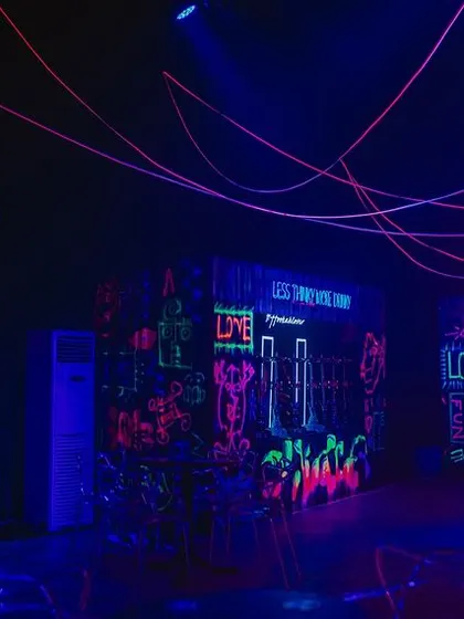 We created a 'graffiti zone' where walls were covered in glowing UV paint art and playful phrases. This interactive area added to the fun, rebellious spirit of the party.