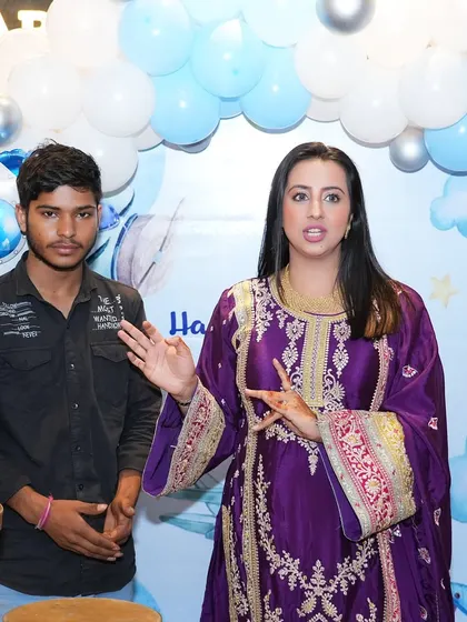 Actress Sanjjanaa Galrani speaking during her son's birthday party, with our blue and white balloon backdrop behind her. It's always a pleasure to work with such wonderful clients.