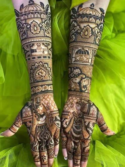 This design features bold, dark-stained figures and motifs, including elephants and a kalash, against a vibrant green background.