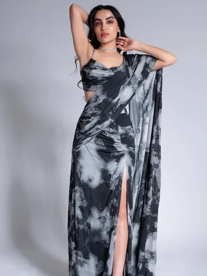 A modern draped saree look. The makeup is soft and romantic, with a focus on luminous skin and a neutral lip color.