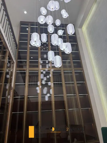 A shot looking up at the stunning, multi-story cascading light fixture in the Defence Colony law office. This feature piece was designed to create a sense of awe and modern elegance.