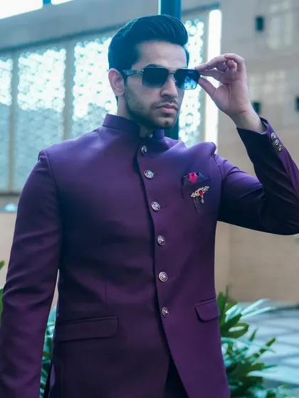 A model showcasing our deep purple Jodhpuri suit. The rich color and sharp tailoring make it a standout piece for any man's ethnic wardrobe.