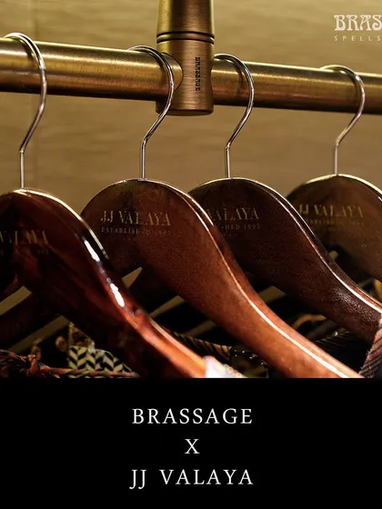 A close-up of the custom hanger rod, showing how it seamlessly integrates with the JJ Valaya branded wooden hangers. This is an example of my commitment to creating a complete, cohesive hardware solution for commercial projects.