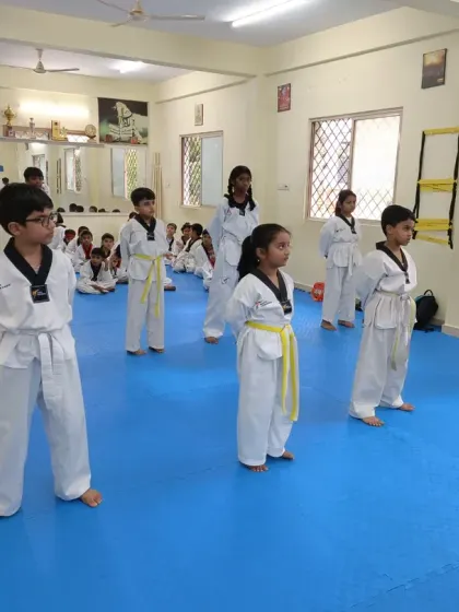 A group of yellow belts in their ready stance.