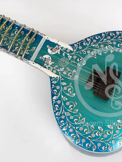 This is our blue rock peacock color design sitar. It features beautiful floral inlay work across the body and neck, with a stunning blue finish.