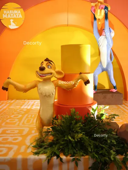 A close-up of the Timon and Rafiki props on the main stage, capturing a classic movie moment.