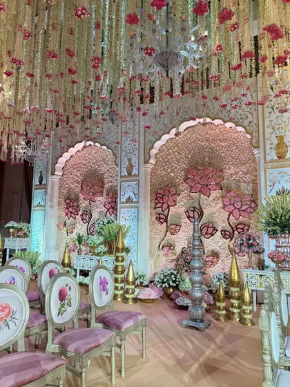 A view of the mandap from the guest seating area. The custom-printed chairs and the grand stage create a cohesive and luxurious experience for everyone in attendance.