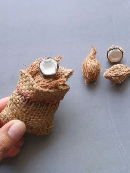 Another angle of the miniature sack of coconuts, showing the realistic texture.