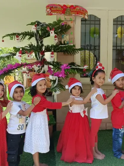 All our little Santas in a row. The children loved dressing up and posing for this Christmas train photo in our outdoor play area.