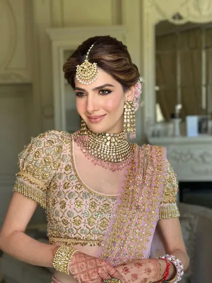 A portrait of bridal perfection. The soft, floral updo and statement jewelry come together to create a look that is both regal and romantic.
