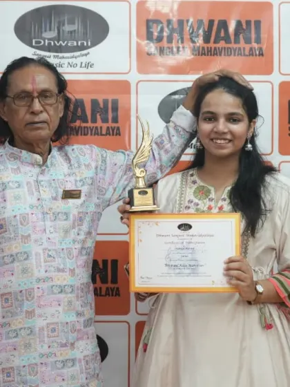 A senior guru with his student, celebrating her achievement.