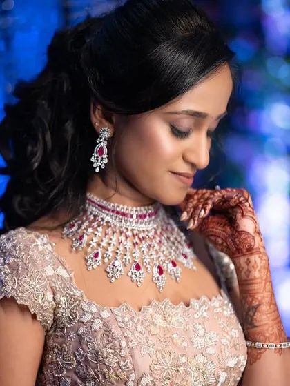 A detailed shot of the makeup for a glamorous evening look. You will learn to perfect this kind of soft smokey eye and matte lip combination, a versatile skill for any makeup artist.