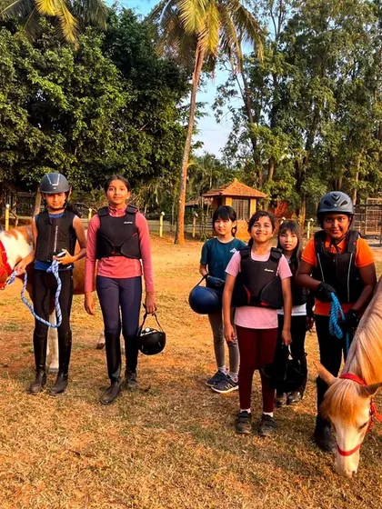 A group of happy campers leads their ponies after a lesson. Our camps are designed to be full of fun, learning, and unforgettable moments for young horse enthusiasts.