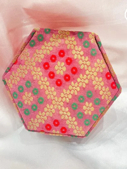 The hexagonal version of our custom jewelry box, shown here in a pink and gold brocade fabric.