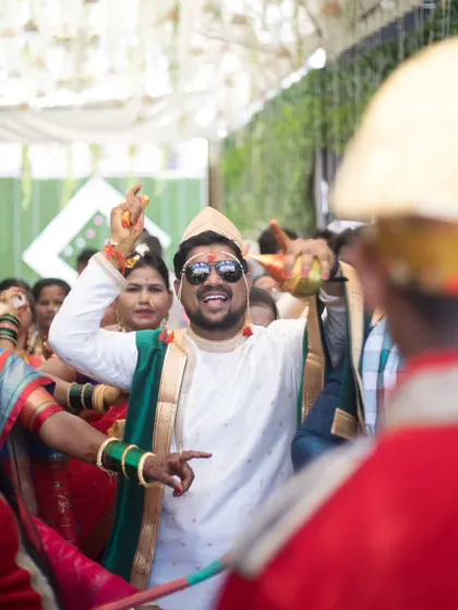 The groom, Akshay, dancing with joy and energy in his baraat, a perfect candid moment of celebration.