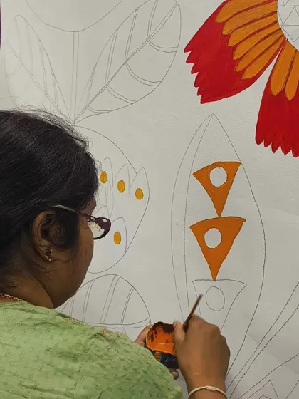 A close-up of me painting the new studio mural. I believe in creating a space that is as colorful and imaginative as the children who learn here.