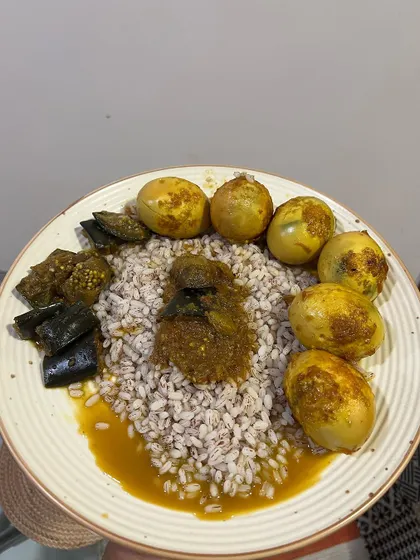 A high-protein meal of barley, eight boiled eggs, and vegetables. This is a powerhouse meal for muscle repair and satiety, perfect for a day with intense training.