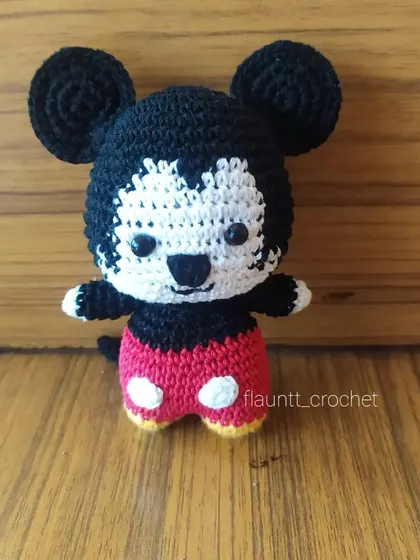 A close-up of my crochet Mickey Mouse toy. I pay special attention to his iconic ears, red shorts, and happy expression. He's a timeless character that brings joy to everyone.