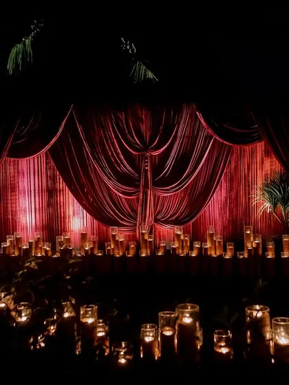 The entrance to the Sangeet was lined with hundreds of candles and draped in rich red velvet, creating a dramatic and welcoming pathway for guests into the main event.