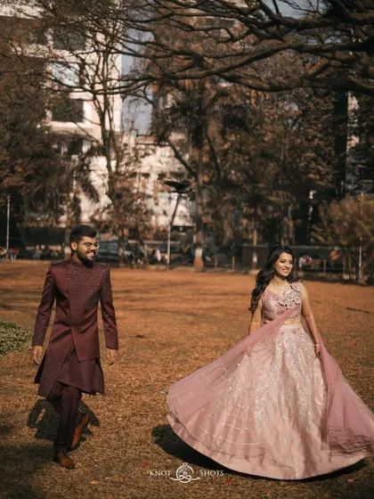 An elegant portrait from an engagement session in a park. The way he looks at her as she twirls her lehenga creates a beautiful, story-driven moment.