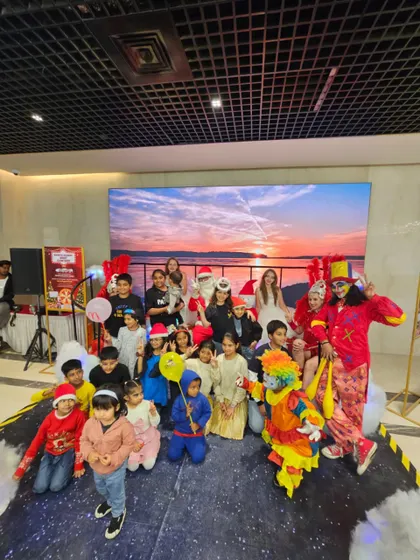 A happy group photo on stage with our performers and young guests. Our clowns, jugglers, and Santa Claus love posing for pictures to help families capture the fun memories from the event.