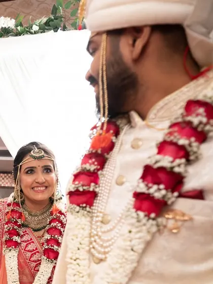 A candid shot of the bride looking at her groom as they walk, capturing a natural, in-between moment.