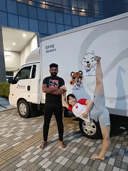Sharing a moment of fun and incredible flexibility with a fellow martial artist from China during our time at the expo in South Korea.