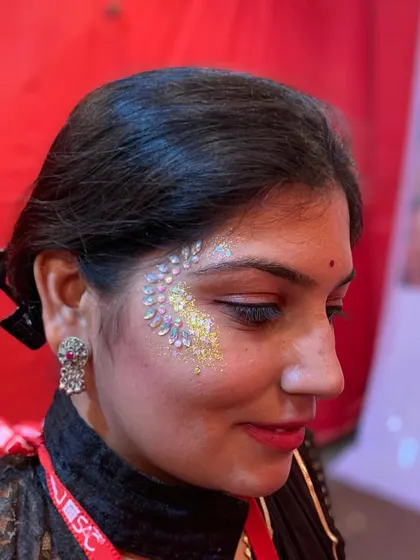 A close-up of a beautiful design using face jewels and glitter, perfect for a festive night.