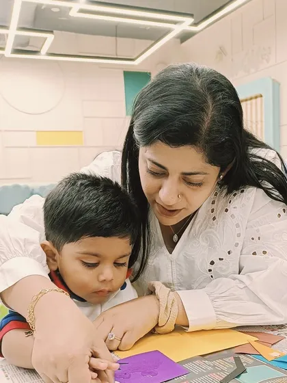 A mother and child at our Ashok Vihar center work together on a craft, showing how our program is consistent across all locations.