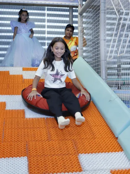 Another happy rider on our doughnut slide. This attraction is a party favorite, offering a unique sliding experience that kids want to try again and again.