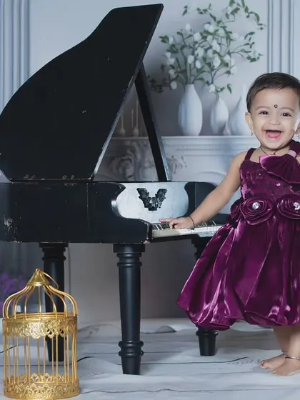 A joyful moment at the piano, with this little girl laughing as she plays.