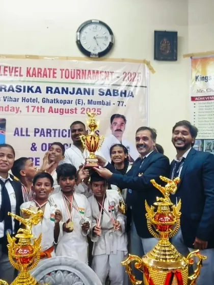 The entire team celebrating with our trophies after a successful tournament. The joy of victory is best when shared.