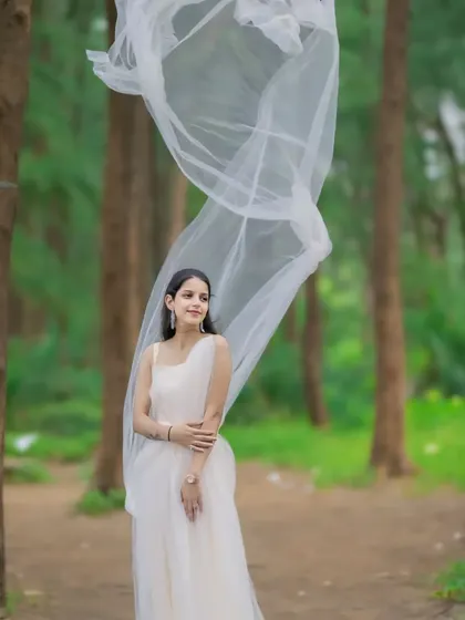This couple's portrait in the woods has a magical feel, thanks to the flowing fabric of our off-white gown. We provide outfits that help tell your unique love story.