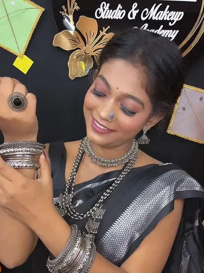 The model admiring her bangles, a shot that highlights the beautiful silver accessories.