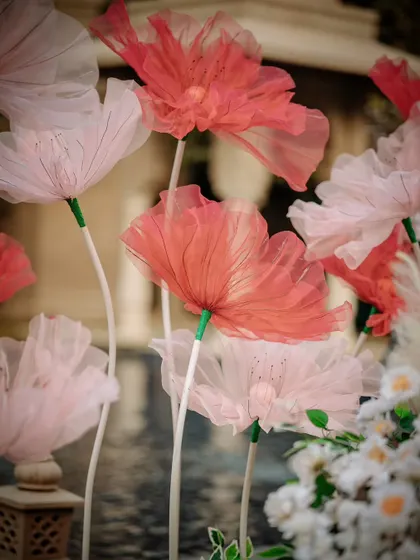 Giant, handcrafted tissue paper flowers added a touch of whimsy and fantasy to the Mehendi decor, creating a stunning visual impact.