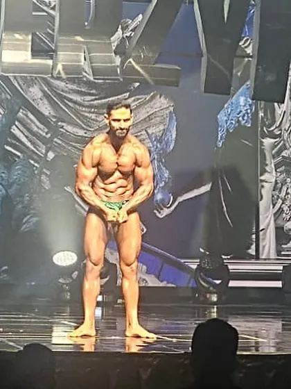 On stage at the Pro Qualifier show in Korea. This moment represents the culmination of 16 weeks of brutal, focused preparation.