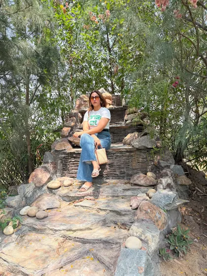 Wander often, style always. Sitting on a rock formation, this comfortable yet stylish outfit is perfect for a travel day that involves a bit of adventure.