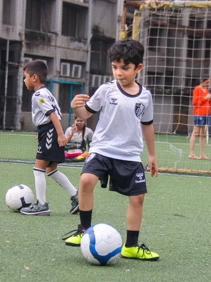 Two players practice ball control side-by-side, learning from each other in a collaborative and supportive training environment.