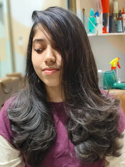 Good hair days start here. A lovely long layered haircut that looks healthy, bouncy, and full of life.