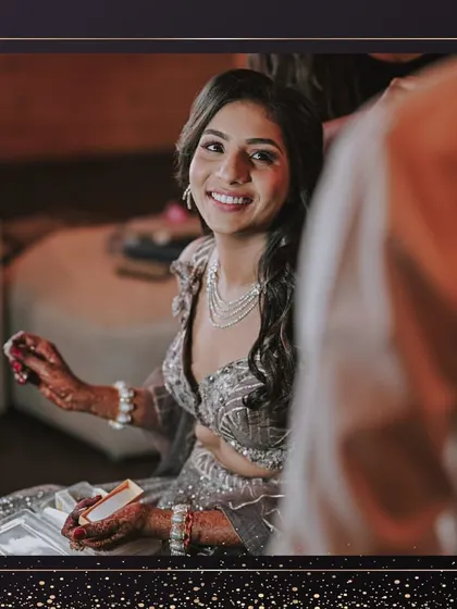 A candid getting-ready shot. The bride's happy smile shows her excitement for the sangeet ceremony, and her makeup is looking flawless.