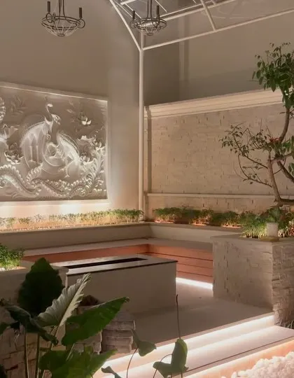 A full view of the semi-enclosed courtyard project at Epsilon layout. The combination of the intricate wall mural, stone planters, wooden seating, and a central water feature creates a truly unique and tranquil space.