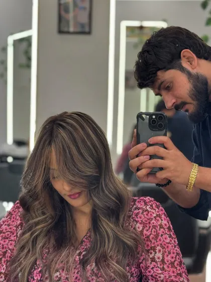 Capturing the perfect shot of a new hair color. This shows the stylist's attention to detail in creating and documenting the Ash Blonde look.