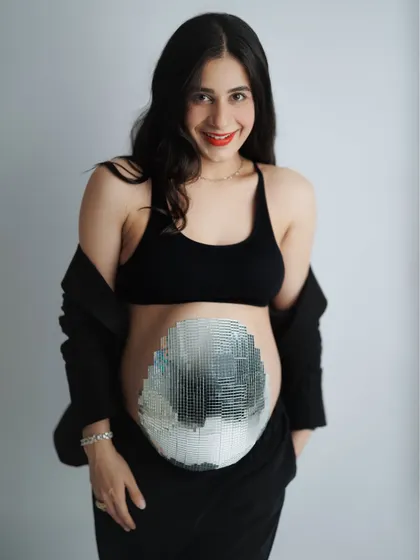 This mama-to-be was just a week away from meeting her little one and wanted a session that was both cozy and quirky. Her family even helped create this amazing mirrorball belly. It was a day full of joy, laughter, and celebrating her beautiful journey.