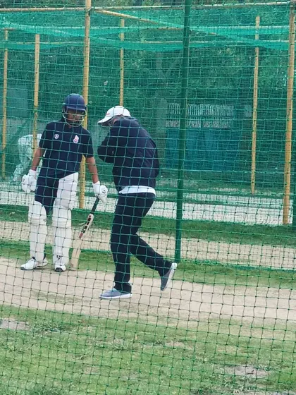 Virender Sehwag demonstrates batting techniques to a trainee during a hands-on net session. Our program ensures that players learn the practical application of skills directly from the masters of the game.