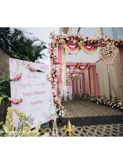 The entrance to the ceremony welcomed guests with a custom sign adorned with floral parrots, echoing a key motif from the decor. This first touchpoint immediately introduced the personalized and elegant theme of the wedding.
