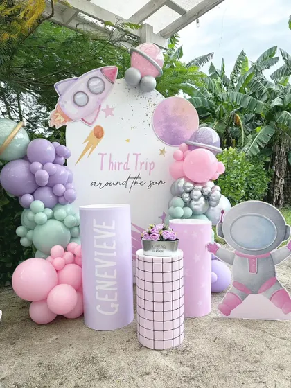 A pastel take on the outer space theme, proving that cosmic can be cute. This "Third Trip Around the Sun" setup uses soft purples and pinks for a whimsical journey among the stars.