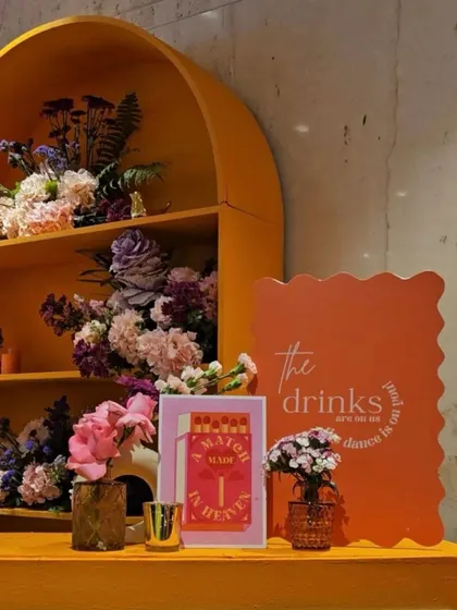 A close-up of the custom-designed event signage and decor details. Every element, from the drink menu to the matchboxes, was themed to create a cohesive and immersive experience for the guests.