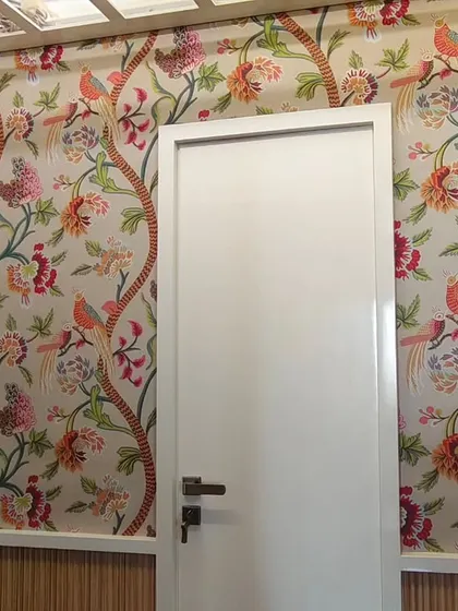 A vibrant, traditional floral and bird wallpaper installed in a Chembur home. I carefully cut the paper to fit perfectly around the door frame for a clean, continuous look.
