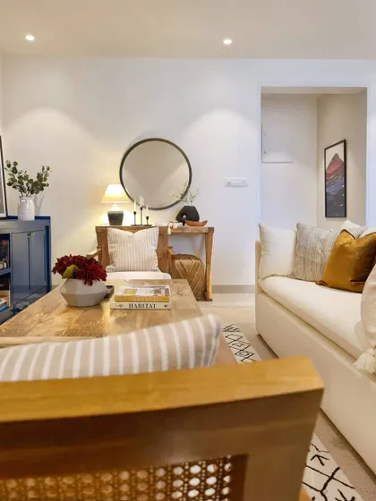 A quiet corner in the Breeze Home, showing how I use balance and composition to create a pleasing vignette. The round mirror above the console table creates a focal point, while the mix of wood tones and textures adds warmth.