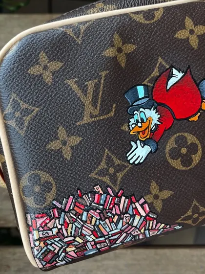 A fun commission for a Disney fan. I painted Scrooge McDuck diving into his money on this Louis Vuitton pouch.
